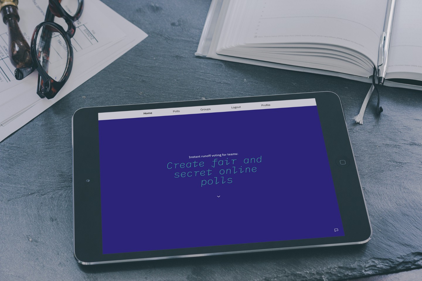 tablet lying in a desk showing the home page of the voting app
