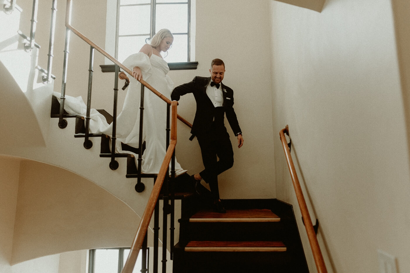 bride and groom walking downstairs