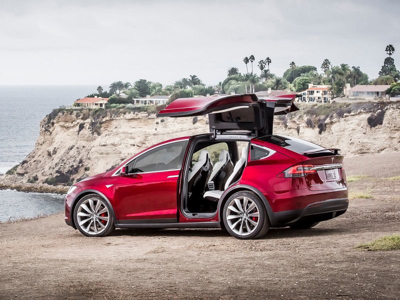 2019 Tesla Model X Red Rear Three Quarter Falcon Doors Up ・  Photo by Tesla 