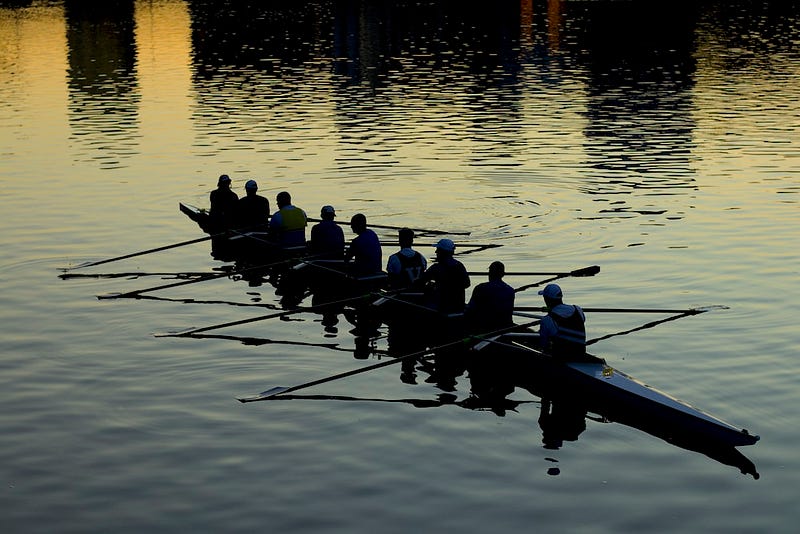 Rowing team in action - metaphor for team coordination and strategy for overcoming challenges.