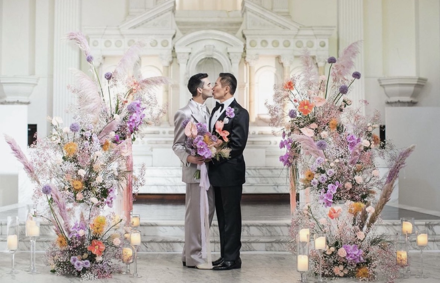 two grooms kissing on Vibiana altar 