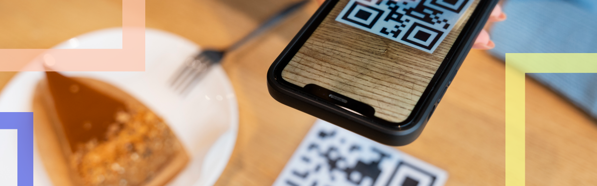 A smartphone scanning a QR code on a table