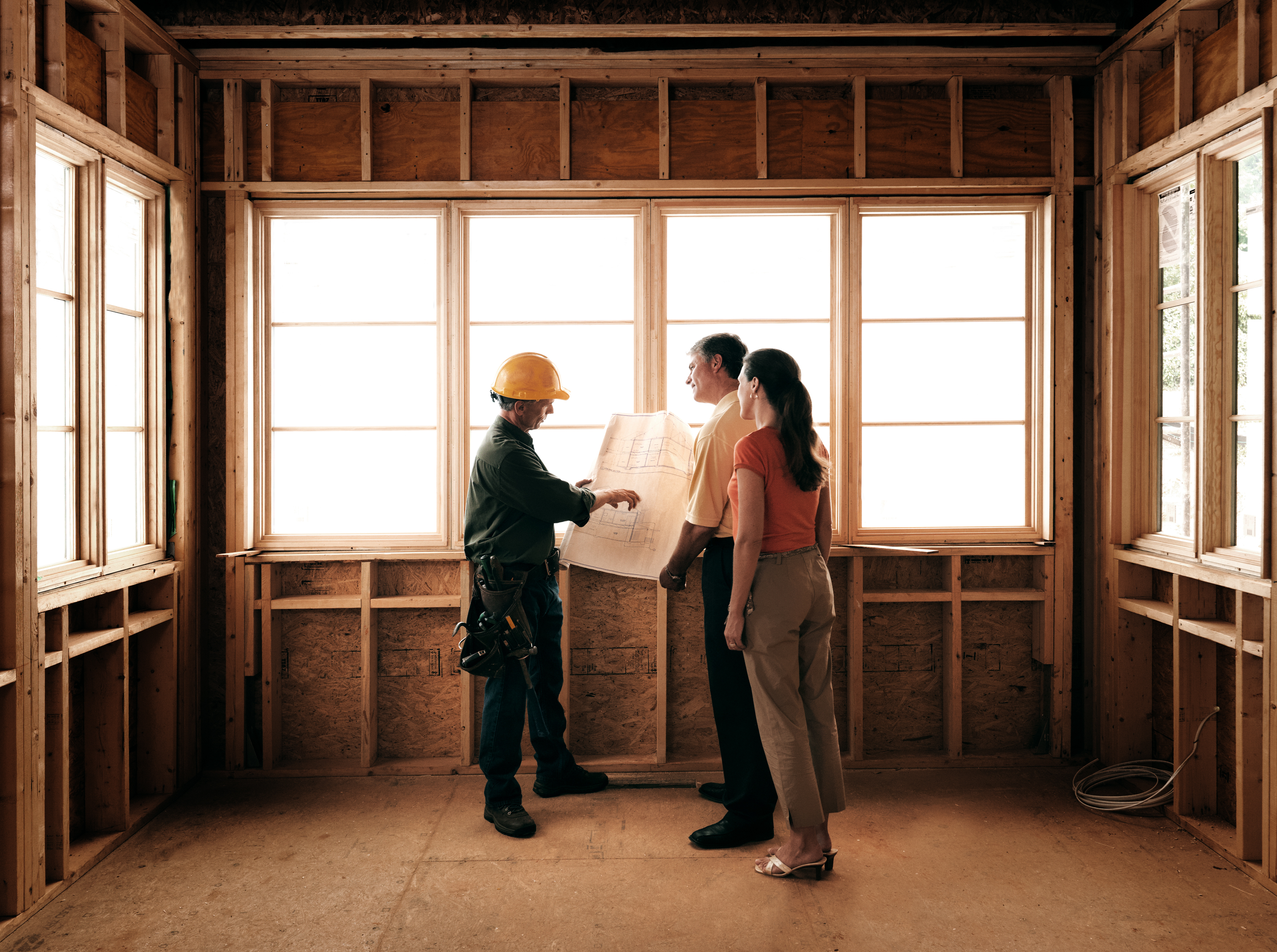 Construction worker discussing floor plan