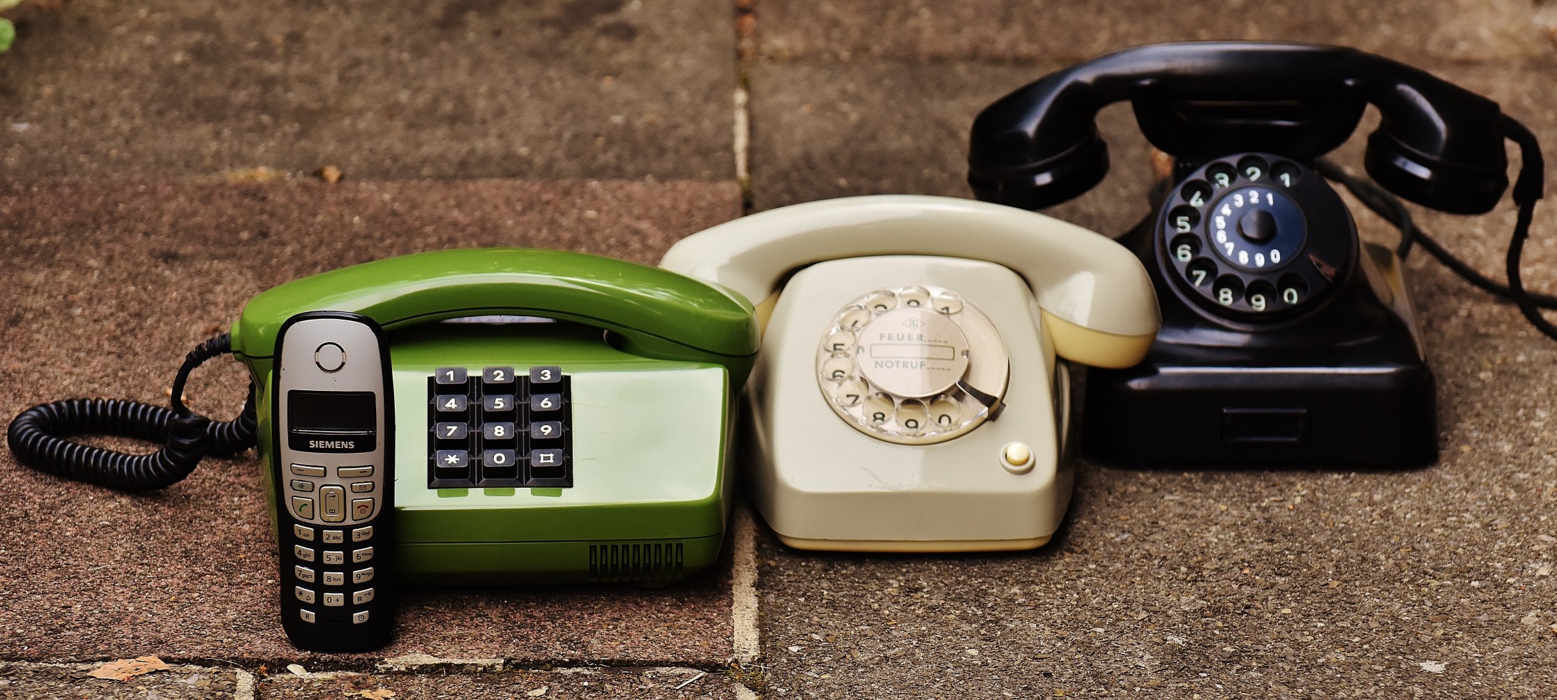 three telephones and a mobile phone image