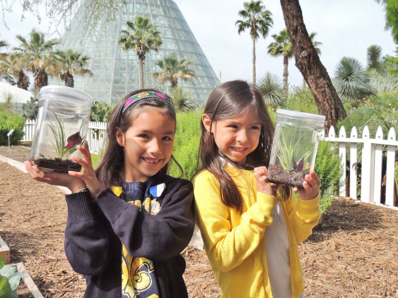 Young guests in the garden. In the background is a portion of the Lucile Halsell Conservatory complex.