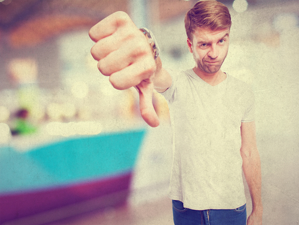 man giving thumbs down gesture for negative facebook reviews