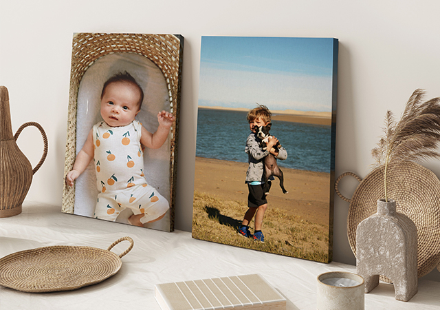 two canvas prints, one of a baby one of a kid holding a dog