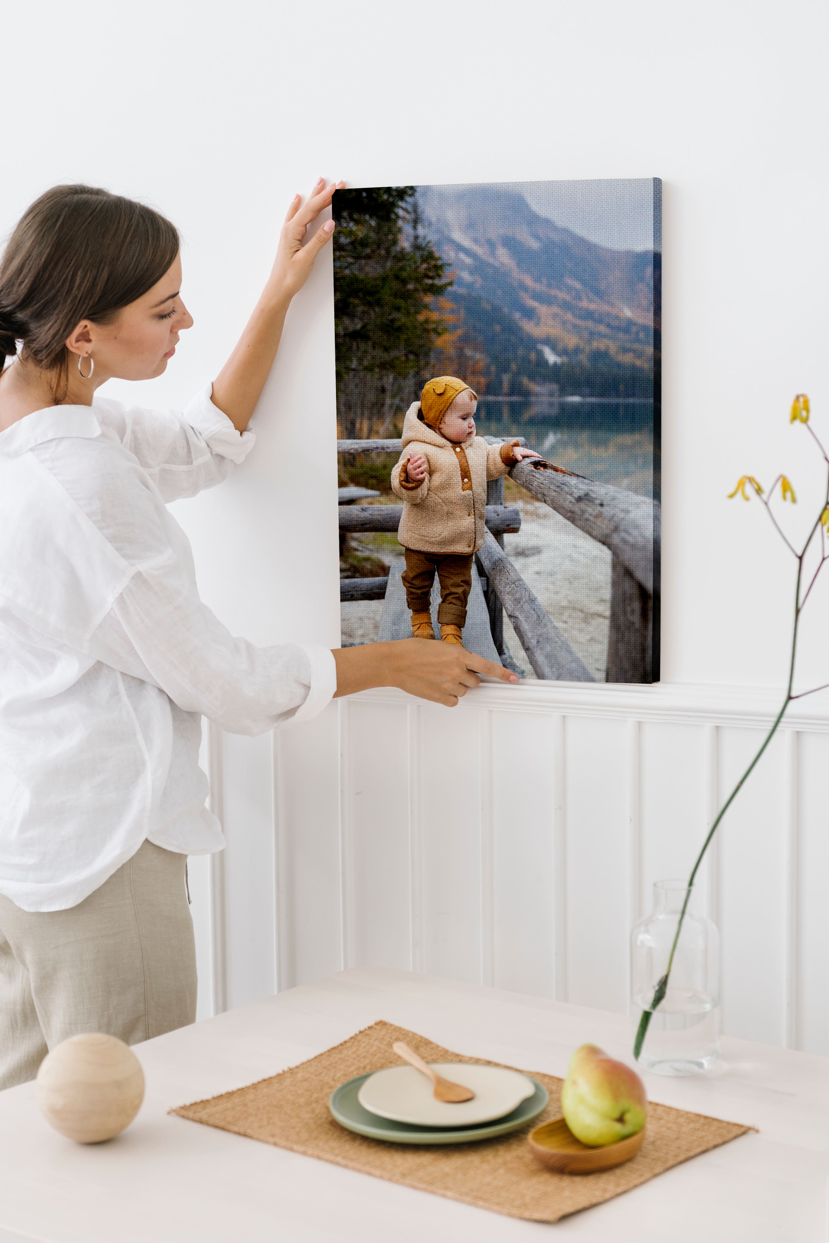 Photo of woman holding canvas print of her child