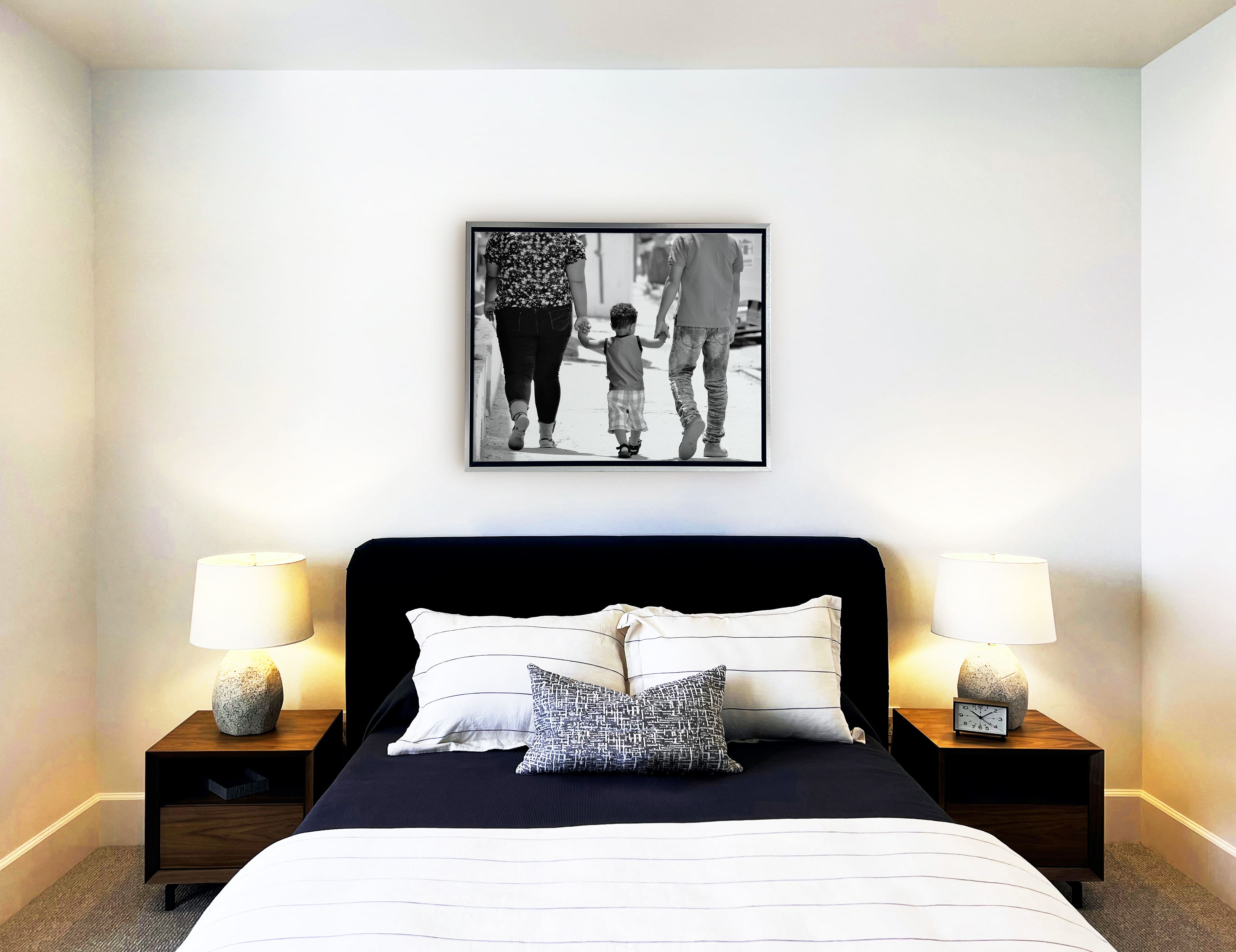 Float frame in bedroom of black and white family portrait