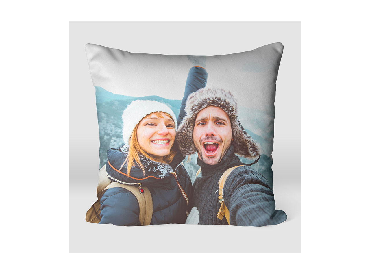 A pillow showcasing a photo of a man and woman on vacation