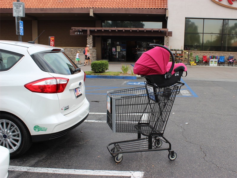 car seat on top of shopping car 