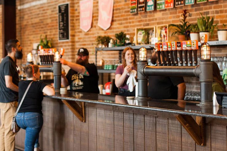 The Armadillo Ale Works taproom has several beers on tap and plenty of customers.