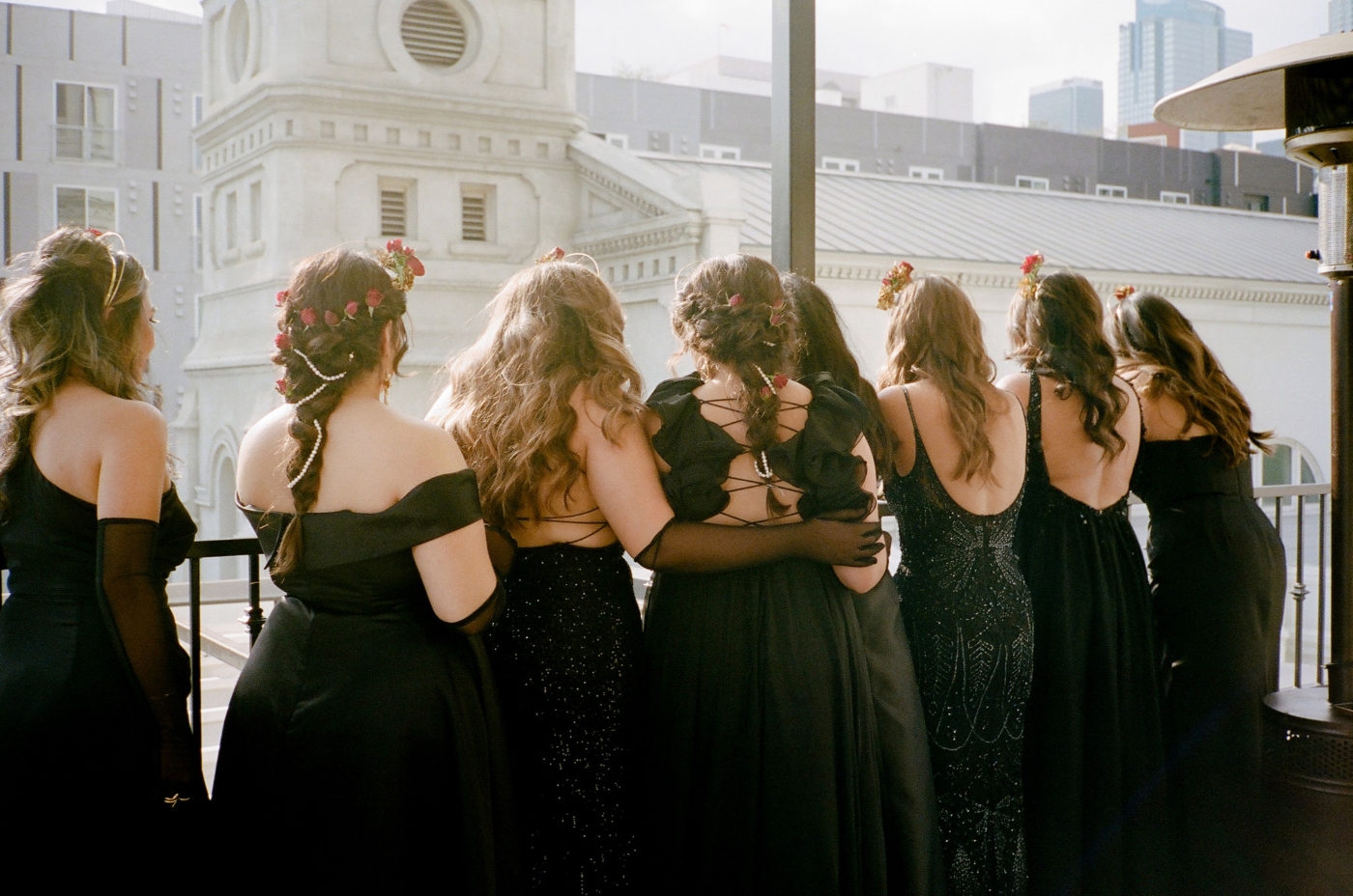 bridesmaids standing on a balcony overlooking the DTLA skyline