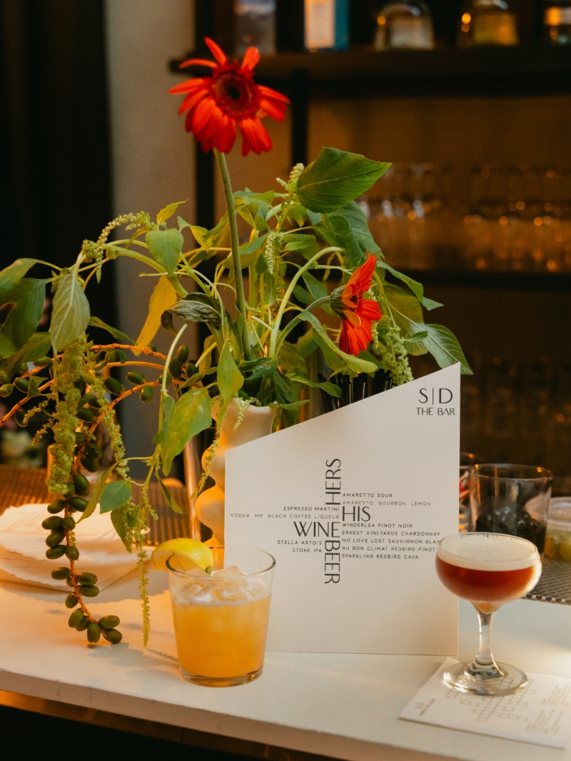 a bar menu with two cocktails and florals at a wedding reception in downtown Los Angeles