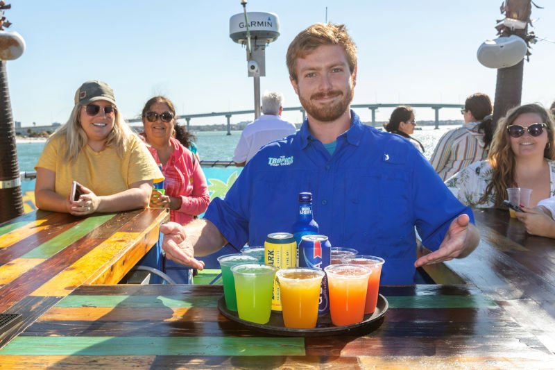 Guests enjoying colorful drinks aboard the tour boat