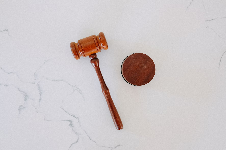 Judges gavel over white marble table.png