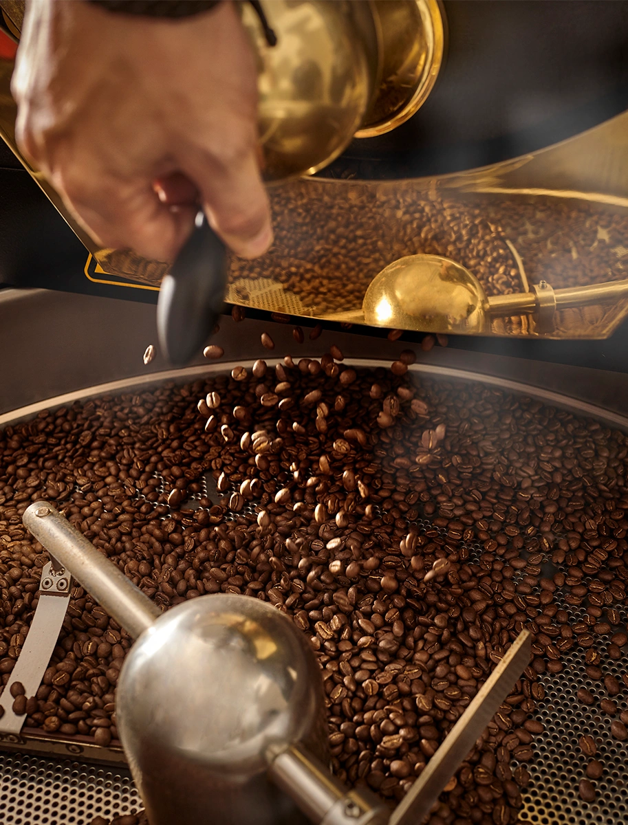 Hand roasting coffee beans with L'OR branding elements for a luxurious touch.