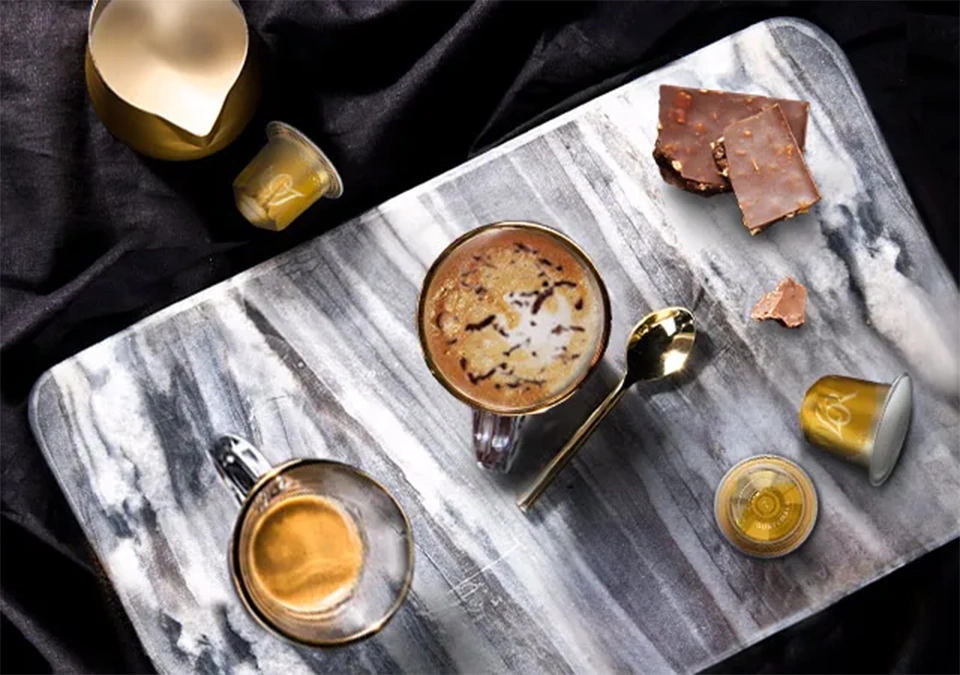 Marble tray with L'OR Espresso pods and chocolates, enhancing the coffee-tasting experience.