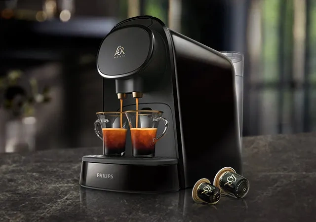 Black coffee machine brewing L'OR Espresso shots for a bold flavor experience.