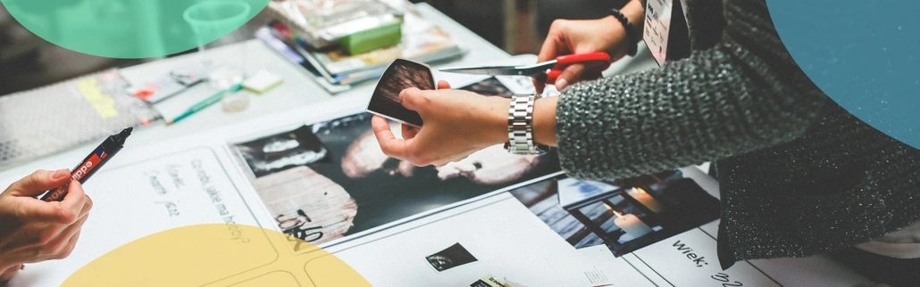 Person cutting out a printed picture