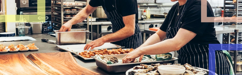 Two people preparing before restaurant work