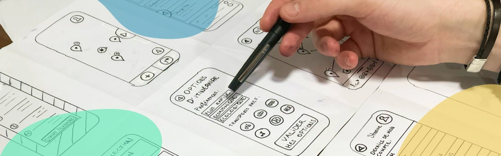 A hand drawing a UX sketch