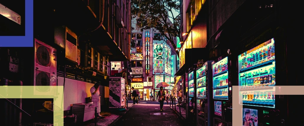 A photo of a city and an alley with vending machines