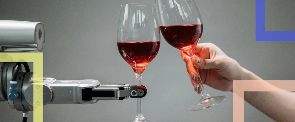 A robot and human hand holding wine glasses 