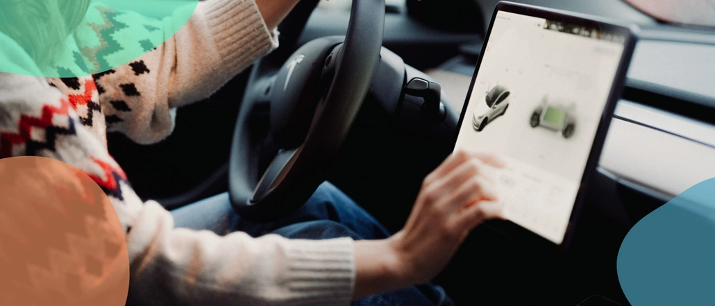 A person in a car operating an on-board computer