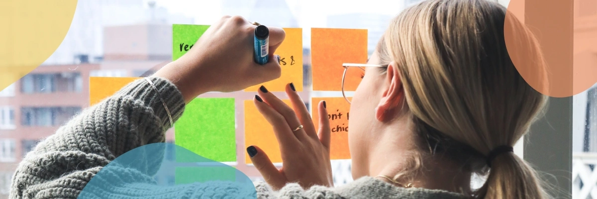 A female writing on sticky notes