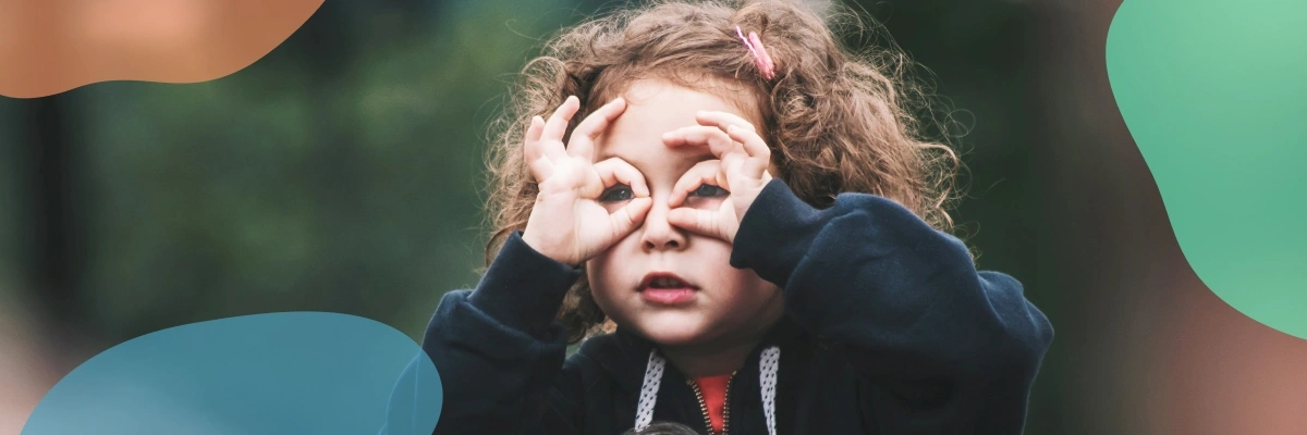 a child making glasses out of their hands