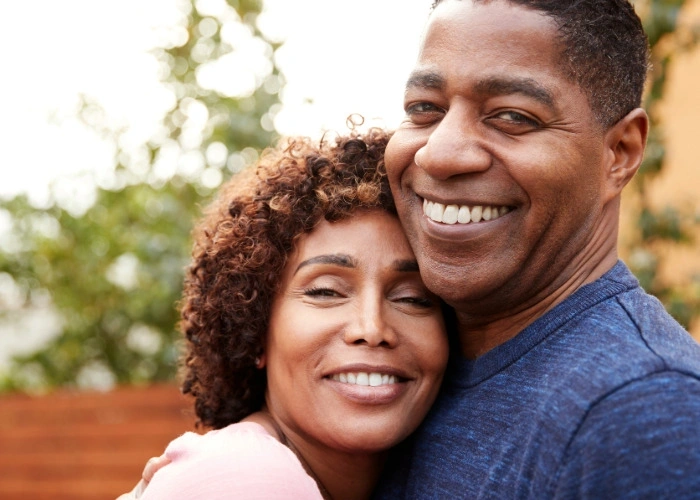 Man smiling with his woman.