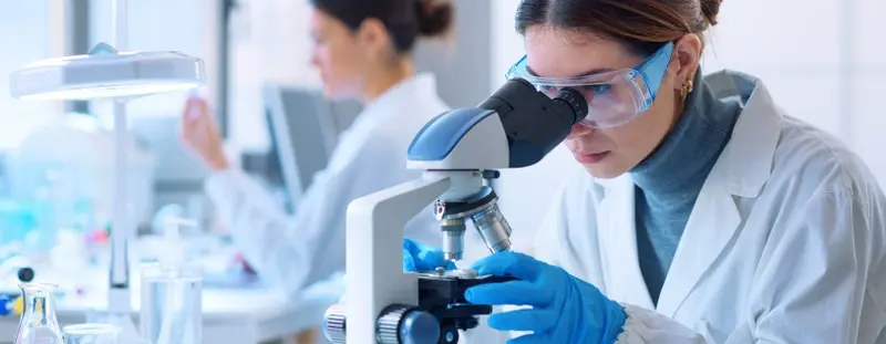 Scientist looking through a microscope