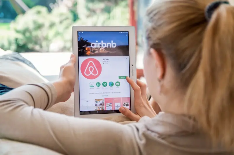 Holidaymaker searching Airbnb app