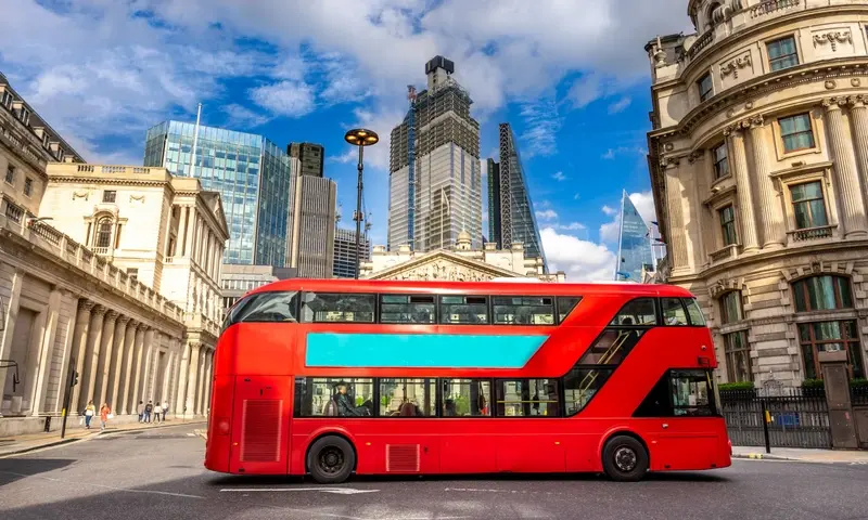 Red bus passing The Royal Exchange