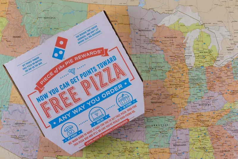 Pizza take out box with Domino's logo on map of US