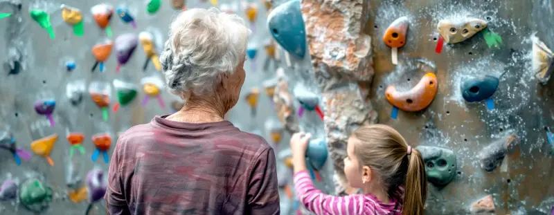 Grandmother and granddaughter at a climbing wall