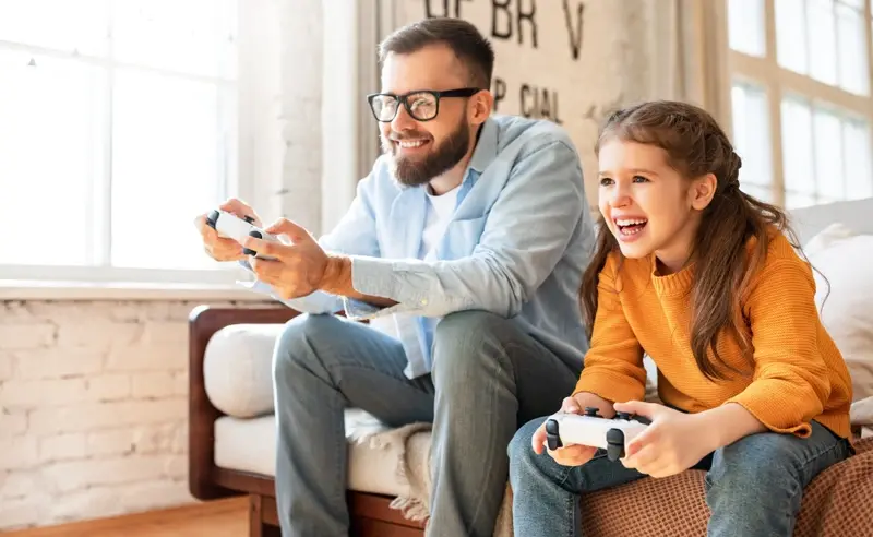 Father and daughter playing video game