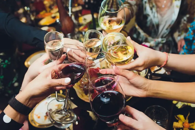 People raising a toast with glasses of wine