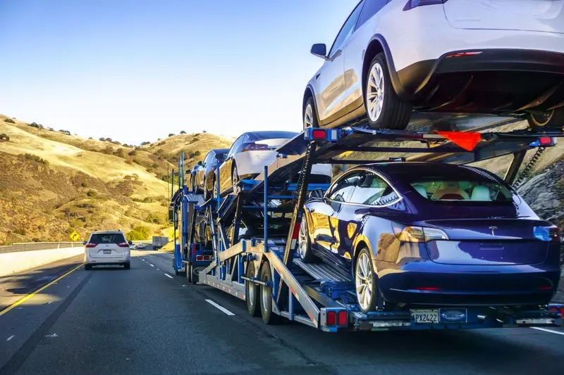 Tesla Model 3s being delivered on truck