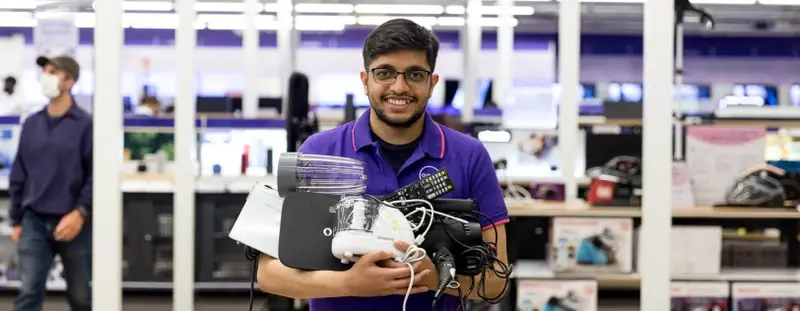 Currys employee holding appliances