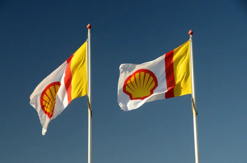 Shell corporate flags flying against a blue sky