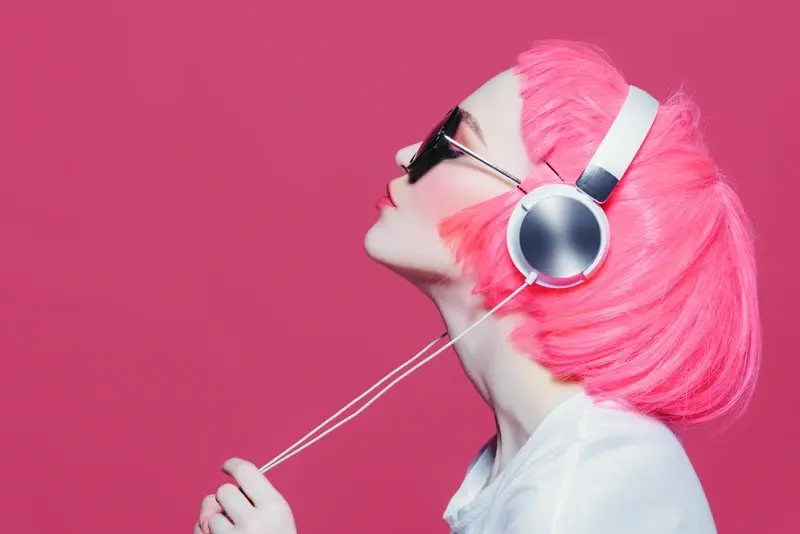 Girl with pink hair listening to music