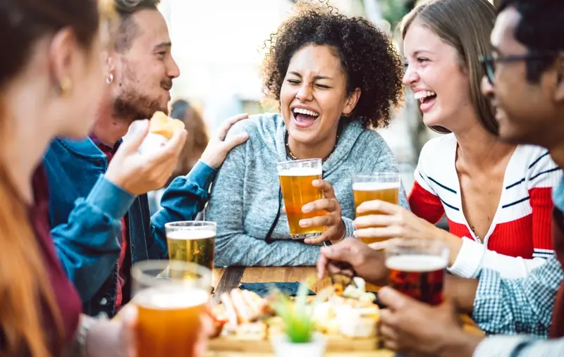 Group of adults drinking in pub garden