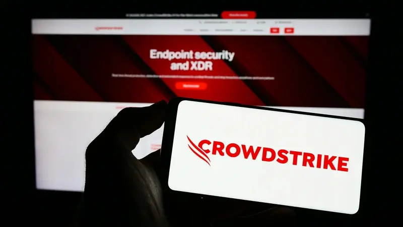 Hand holding mobile with CrowdStrike security app