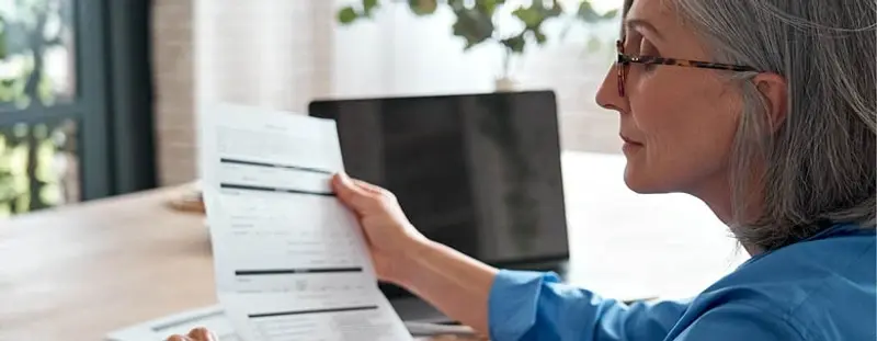 Older woman looking at document