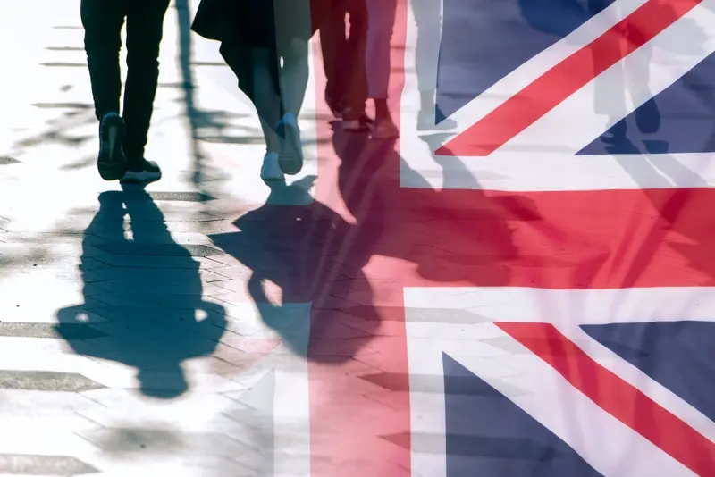 Shadows of people and UK flag