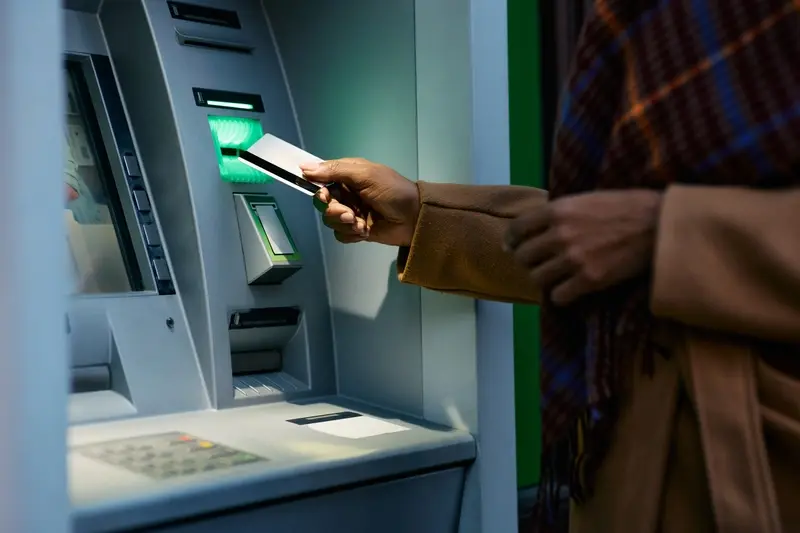 Lady using cash machine 
