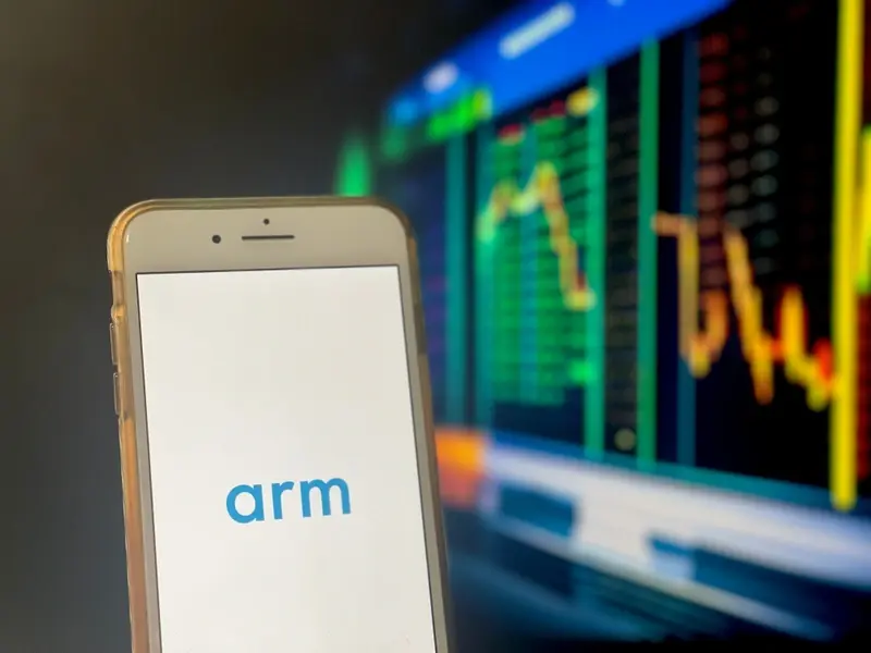 ARM banner on mobile against market data backdrop