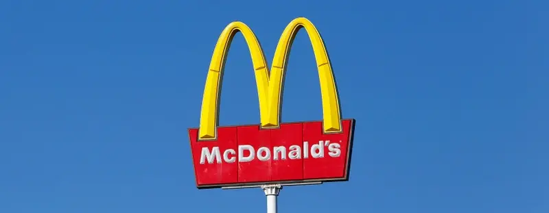 Mcdonalds sign against a blue sky